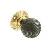 Ebony ribbed knob on brass rose